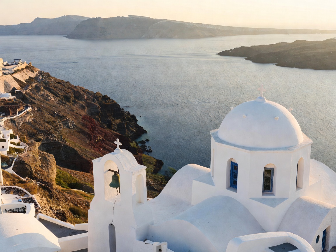 Scenic panoramic view of white bell towers overlooking the volcanic caldera in Santorini